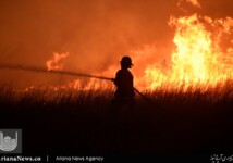 A firefighter tries to control a wildfire that has grown to 400,000 acres