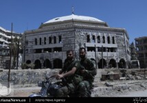 Syrian soldiers ride past the grand mosque
