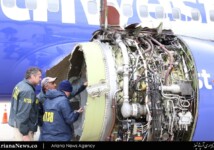 US investigators examine damage to the engine of a Southwest Airlines Boeing 737 700 that had exploded in flight causing the death of one passenger
